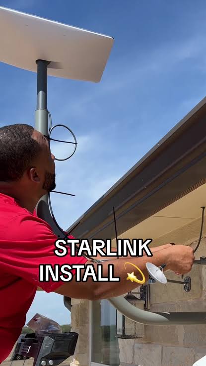 Starlink installer working on dish